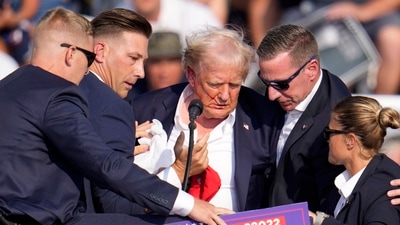 Republican presidential candidate former President Donald Trump is helped off the stage at a campaign event in Butler, Pa., on Saturday, July 13, 2024. AP/PTI(AP07_14_2024_000022A) (AP) Republican presidential candidate former President Donald Trump is helped off the stage at a campaign event in Butler, Pa., on Saturday, July 13, 2024. AP/PTI(AP07_14_2024_000022A) (AP)