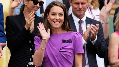 Kate was wearing a purple dress — one of Wimbledon's official colours. (AP) Kate was wearing a purple dress — one of Wimbledon's official colours. (AP)