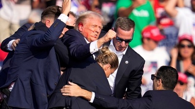 Republican presidential candidate former President Donald Trump is helped off the stage at a campaign event in Butler, Pa., on Saturday, July 13, 2024. (AP Photo/Gene J. Puskar) (AP) Republican presidential candidate former President Donald Trump is helped off the stage at a campaign event in Butler, Pa., on Saturday, July 13, 2024. (AP Photo/Gene J. Puskar) (AP)