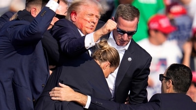 Republican presidential candidate former President Donald Trump is helped off the stage at a campaign event in Butler, Pa., on Saturday, July 13, 2024. (AP Photo/Gene J. Puskar) (AP) Republican presidential candidate former President Donald Trump is helped off the stage at a campaign event in Butler, Pa., on Saturday, July 13, 2024. (AP Photo/Gene J. Puskar) (AP)