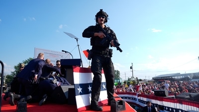 Former President Donald Trump encircled by US Secret Service agents on stage during a campaign rally in Butler on Saturday, July 13, 2024." (AP) Former President Donald Trump encircled by US Secret Service agents on stage during a campaign rally in Butler on Saturday, July 13, 2024." (AP)