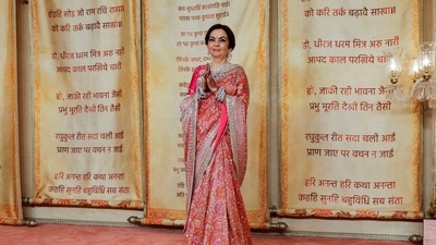Nita Ambani, wife of Mukesh Ambani, poses for pictures on the red carpet. (REUTERS)