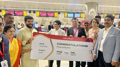 Pune MP and minister of state for civil aviation Murlidhar Mohol handed over a boarding pass to the first passenger of the Air India flight from Pune to Delhi. (HT PHOTO) Pune MP and minister of state for civil aviation Murlidhar Mohol handed over a boarding pass to the first passenger of the Air India flight from Pune to Delhi. (HT PHOTO)