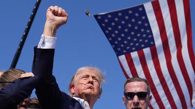 Republican presidential candidate former President Donald Trump reacts as he is surrounded by US Secret Service agents at a campaign rally, on Saturday, in Butler, Pennsylvania. (AP) Republican presidential candidate former President Donald Trump reacts as he is surrounded by US Secret Service agents at a campaign rally, on Saturday, in Butler, Pennsylvania. (AP)