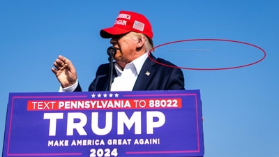 Photo by New York Times photographer Doug Mills shows a bullet flying just behind Trump's head. (New York Times) Photo by New York Times photographer Doug Mills shows a bullet flying just behind Trump's head. (New York Times)