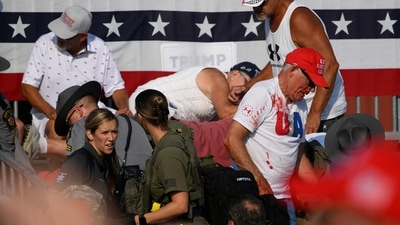 Attendees dispersed after gunfire erupted at a campaign rally for Republican presidential candidate and former US President Donald Trump at Butler Farm Show Inc. on July 13, 2024. (AFP) Attendees dispersed after gunfire erupted at a campaign rally for Republican presidential candidate and former US President Donald Trump at Butler Farm Show Inc. on July 13, 2024. (AFP)