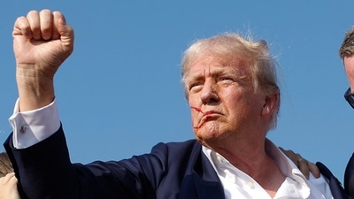 Donald Trump pumps his fist as he is rushed offstage by U.S. Secret Service agents after being grazed by a bullet during a rally on July 13, 2024 in Butler, Pennsylvania (Photo by Anna Moneymaker / GETTY IMAGES NORTH AMERICA / Getty Images via AFP) (Getty Images via AFP) Donald Trump pumps his fist as he is rushed offstage by U.S. Secret Service agents after being grazed by a bullet during a rally on July 13, 2024 in Butler, Pennsylvania (Photo by Anna Moneymaker / GETTY IMAGES NORTH AMERICA / Getty Images via AFP) (Getty Images via AFP)