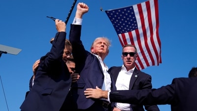 Republican presidential candidate former President Donald Trump gestures as he is surrounded by U.S. Secret Service agents as he leaves the stage at a campaign rally, Saturday, July 13, 2024, in Butler, Pa. (AP)
