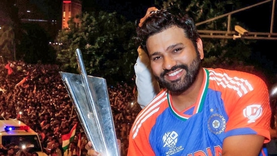 India's captain Rohit Sharma shows T20 World Cup trophy to a huge crowd of fans during the victory parade, in Mumbai (ICC - X )