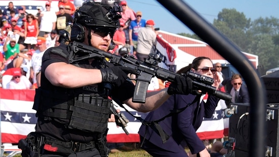 U.S. Secret Service agents surrounded the stage while others shielded Republican presidential candidate and former President Donald Trump during a campaign rally on Saturday, July 13, 2024. The gunman and a bystander were killed, and two spectators were critically injured.(AP)