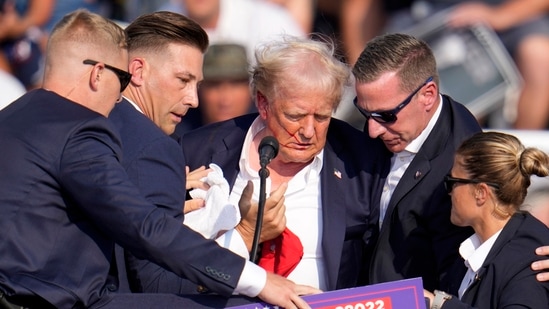 Republican presidential candidate former President Donald Trump is helped off the stage at a campaign event in Butler, Pa., on Saturday, July 13, 2024. AP/PTI(AP07_14_2024_000022A)(AP)