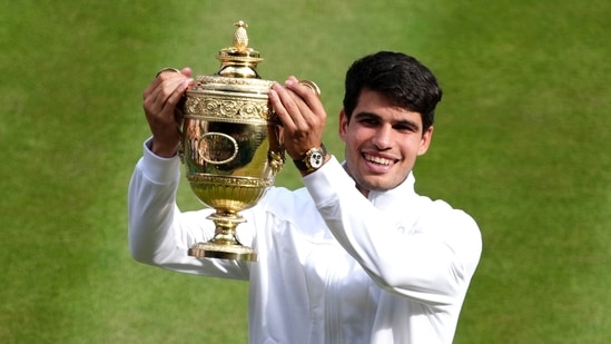 Carlos Alcaraz beat Novak Djokovic 6-2, 6-2, 7-6 (4) in the Wimbledon men's final on Sunday to retain his title.(AP)