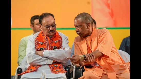 Chief Minister Yogi Adityanath interacts with Union Minister and BJP National President JP Nadda during the party’s state working committee meeting, in Lucknow, Sunday (PTI)