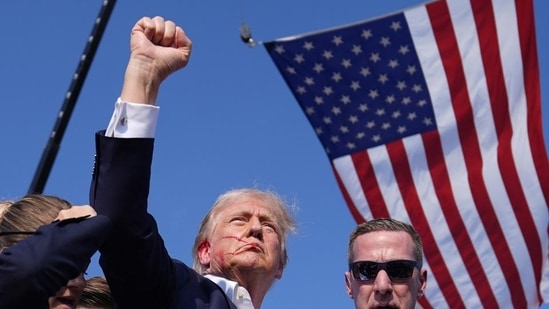 Donald Trump raising his fist in the air with blood dripping from his ear to his face. (AP)(HT_PRINT)