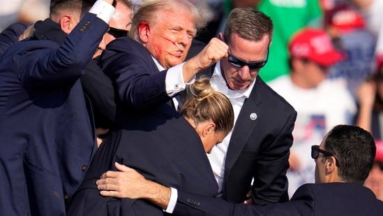 Republican presidential candidate former President Donald Trump is helped off the stage at a campaign event in Butler, Pa., on Saturday, July 13, 2024. (AP Photo/Gene J. Puskar)(AP)