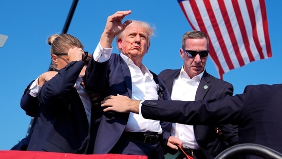 Republican presidential candidate former President Donald Trump is surrounded by US Secret Service agents as he leaves the stage at a campaign rally, Saturday, July 13, 2024 in Pennsylvania.(AP)