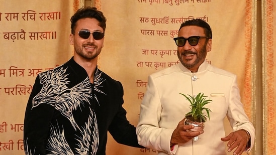 Bollywood actors Jackie Shroff (R) poses with son Tiger Shroff as they arrive for the wedding reception of billionaire Mukesh Ambani's son Anant Ambani and Radhika Merchant.(AFP)