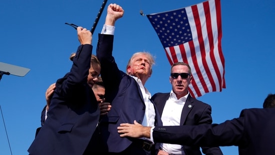 Republican presidential candidate former President Donald Trump gestures as he is surrounded by U.S. Secret Service agents as he leaves the stage at a campaign rally, Saturday, July 13, 2024, in Butler, Pa.(AP)