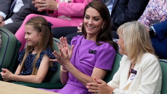 Kate, Princess of Wales, center, and her daughter Princess Charlotte, left, watch the men's singles final between Carlos Alcaraz of Spain and Novak Djokovic of Serbia, from the Royal Box at the Wimbledon tennis championships in London.(AP)