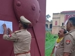 Cops pasting a notice of house arrest on the gates of “Bhadri Kothi” in Pratapgarh on July 15. (HT photo) Cops pasting a notice of house arrest on the gates of “Bhadri Kothi” in Pratapgarh on July 15. (HT photo)