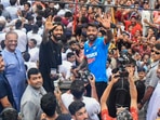 Hardik Pandya and his brother and fellow cricketer Krunal Pandya wave during a roadshow to celebrate India's victory in the T20 World Cup. Hardik Pandya and his brother and fellow cricketer Krunal Pandya wave during a roadshow to celebrate India's victory in the T20 World Cup.