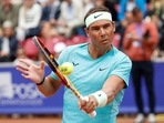 Spain's Rafael Nadal returns the ball as he plays with Norway's Casper Ruud (Unseen) during the men's doubles tennis match(AFP) Spain's Rafael Nadal returns the ball as he plays with Norway's Casper Ruud (Unseen) during the men's doubles tennis match(AFP)