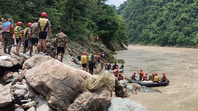 Nepal army personnel cary out a search operation looking for the survivors after two buses were swept by a landslide (AP/PTI) (AP) Nepal army personnel cary out a search operation looking for the survivors after two buses were swept by a landslide (AP/PTI) (AP)