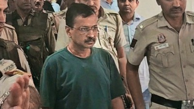 Delhi CM and Aam Aadmi Party (AAP) national convenor Arvind Kejriwal being brought out of the courtroom for tea and biscuits after his sugar level dropped, at Rouse Avenue Court in New Delhi.. (PTI file) (PTI)