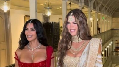 American media personalities and sisters Kim Kardashian and Khloe Kardashian pose as they leave for Anant Ambani and Radhika Merchant's wedding, in Mumbai. While Kim wore a glittering red lehenga-saree, Khloe opted for an ivory-gold lehenga-saree with heavy embellishments. (PTI) American media personalities and sisters Kim Kardashian and Khloe Kardashian pose as they leave for Anant Ambani and Radhika Merchant's wedding, in Mumbai. While Kim wore a glittering red lehenga-saree, Khloe opted for an ivory-gold lehenga-saree with heavy embellishments. (PTI)