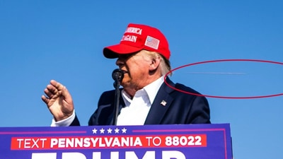 Photo by New York Times photographer Doug Mills shows a bullet flying just behind Trump's head. (New York Times) Photo by New York Times photographer Doug Mills shows a bullet flying just behind Trump's head. (New York Times)