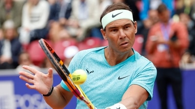 Spain's Rafael Nadal returns the ball as he plays with Norway's Casper Ruud (Unseen) during the men's doubles tennis match (AFP)