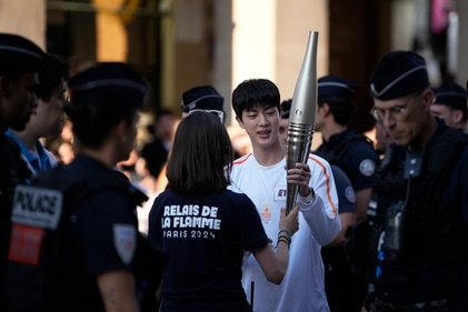 Jin, the oldest member of K-pop supergroup BTS, is given the Olympic torch, in Paris. (AP) Jin, the oldest member of K-pop supergroup BTS, is given the Olympic torch, in Paris. (AP)