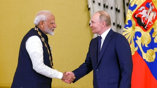 Prime Minister Narendra Modi exchanges greetings with Russian President Vladimir Putin after receiving the Order of St Andrew the Apostle the First-Called, Russia's highest civilian honour, at St Catherine's Hall, in Moscow on Tuesday. (ANI)