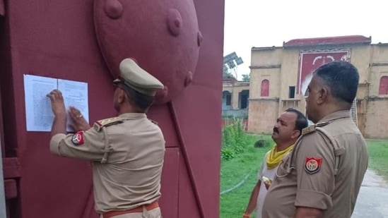 Cops pasting a notice of house arrest on the gates of “Bhadri Kothi” in Pratapgarh on July 15. (HT photo)