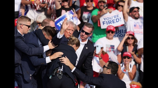 FILE PHOTO: Republican presidential candidate and former U.S. President Donald Trump gestures with a bloodied face while he is assisted by U.S. Secret Service personnel after he was shot in the right ear during a campaign rally at the Butler Farm Show in Butler, Pennsylvania, U.S., July 13, 2024. REUTERS/Brendan McDermid/File Photo (REUTERS)