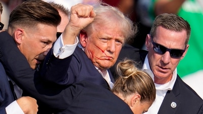 Republican presidential candidate former President Donald Trump is helped off the stage by U.S. Secret Service agents at a campaign event in Butler, Pa., on Saturday, July 13, 2024. (AP) Republican presidential candidate former President Donald Trump is helped off the stage by U.S. Secret Service agents at a campaign event in Butler, Pa., on Saturday, July 13, 2024. (AP)