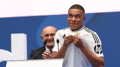 French forward Kylian Mbappe (R) greets fans next to the honorary president of Real Madrid Jose Martinez Pirri during his first appearance as a Real Madrid player at the Santiago Bernabeu Stadium in Madrid (AFP) French forward Kylian Mbappe (R) greets fans next to the honorary president of Real Madrid Jose Martinez Pirri during his first appearance as a Real Madrid player at the Santiago Bernabeu Stadium in Madrid (AFP)