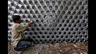 FILE PHOTO: A worker checks sift joints used for cement filtration at its manufacturing factory in the industrial area of Kolkata June 12, 2012. REUTERS/Rupak De Chowdhuri (INDIA - Tags: BUSINESS EMPLOYMENT)/File Photo (REUTERS)