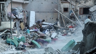 Palestinians inspect at the site of an Israeli strike on a house, amid the Israel-Hamas conflict, in the central Gaza Strip (REUTERS)
