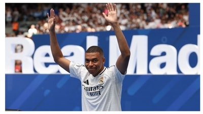 Mbappe posed with the famous Real jersey alongside club president Perez. Mbappe posed with the famous Real jersey alongside club president Perez.