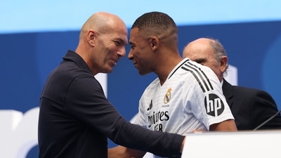 Kylian Mbappe (C) is congratulated by French icon Zinedine Zidane (L) during his first appearance as a Real Madrid player at the Santiago Bernabeu (AFP) Kylian Mbappe (C) is congratulated by French icon Zinedine Zidane (L) during his first appearance as a Real Madrid player at the Santiago Bernabeu (AFP)