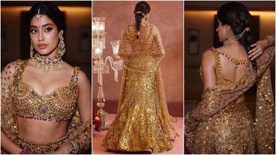 Janhvi paired the bralette and lehenga set with a net dupatta decked in floral-pattern golden sequins. She styled the opulent ensemble with a choker necklace, chandbalis, ear chains attached to the braided hairdo, a mang tika, kadhas, rings, winged eyeliner, gold eye shadow, darkened brows, mascara-adorned lashes, rouged cheeks, and glossy pink lips. (Instagram) Janhvi paired the bralette and lehenga set with a net dupatta decked in floral-pattern golden sequins. She styled the opulent ensemble with a choker necklace, chandbalis, ear chains attached to the braided hairdo, a mang tika, kadhas, rings, winged eyeliner, gold eye shadow, darkened brows, mascara-adorned lashes, rouged cheeks, and glossy pink lips. (Instagram)