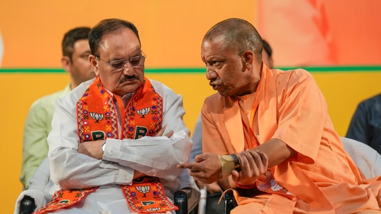 Chief Minister Yogi Adityanath interacts with Union Minister and BJP National President JP Nadda during the party’s state working committee meeting, in Lucknow, Sunday (PTI)