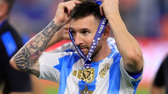 Lionel Messi of Argentina puts on his medal after a victory in the CONMEBOL Copa America 2024 Final against Colombia(Getty Images via AFP)