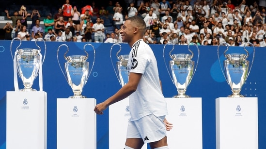 Kylian Mbappe walks to the stage during the presentation at the Santiago Bernabeu (REUTERS)