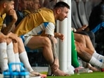 Argentina's Lionel Messi touches his ankle sitting at the bench during a Copa America soccer final match against Colombia in Miami Gardens(AP)