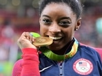 US gymnast Simone Biles celebrates with her gold medal after the women's individual all-around final of the Artistic Gymnastics at the Olympic Arena during the Rio 2016 Olympic Games. US gymnast Simone Biles celebrates with her gold medal after the women's individual all-around final of the Artistic Gymnastics at the Olympic Arena during the Rio 2016 Olympic Games.