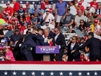 Republican presidential candidate and former U.S. President Donald Trump is assisted by U.S. Secret Service personnel after he was shot in the right ear during a campaign rally at the Butler Farm Show in Butler, Pennsylvania, U.S., July 13, 2024. REUTERS/Brendan McDermi