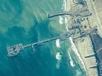 FILE - The image provided by U.S, Central Command, shows U.S. Army soldiers assigned to the 7th Transportation Brigade (Expeditionary), U.S. Navy sailors assigned to Amphibious Construction Battalion 1, and Israel Defense Forces placing the Trident Pier on the coast of Gaza Strip on May 16, 2024. (U.S. Central Command via AP) FILE - The image provided by U.S, Central Command, shows U.S. Army soldiers assigned to the 7th Transportation Brigade (Expeditionary), U.S. Navy sailors assigned to Amphibious Construction Battalion 1, and Israel Defense Forces placing the Trident Pier on the coast of Gaza Strip on May 16, 2024. (U.S. Central Command via AP)