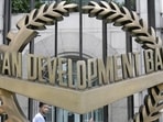 A worker walks past inside the Asian Development Bank (ADB) headquarters in Manila. A worker walks past inside the Asian Development Bank (ADB) headquarters in Manila.
